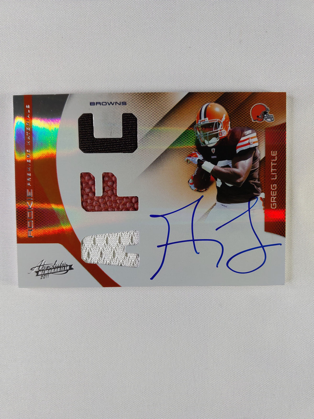 Front of 2011 Absolute Memorabilia Greg Little Rookie Premiere Materials #231 featuring an on-card rookie autograph and triple memorabilia, numbered 02/49.
