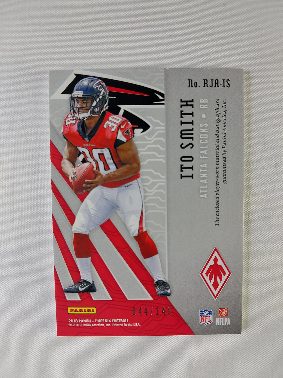 Back of 2018 Panini Phoenix Ito Smith Orange Rookie Jersey Autograph #RJA-IS showing serial number 044/149 and Panini player-worn memorabilia authentication.