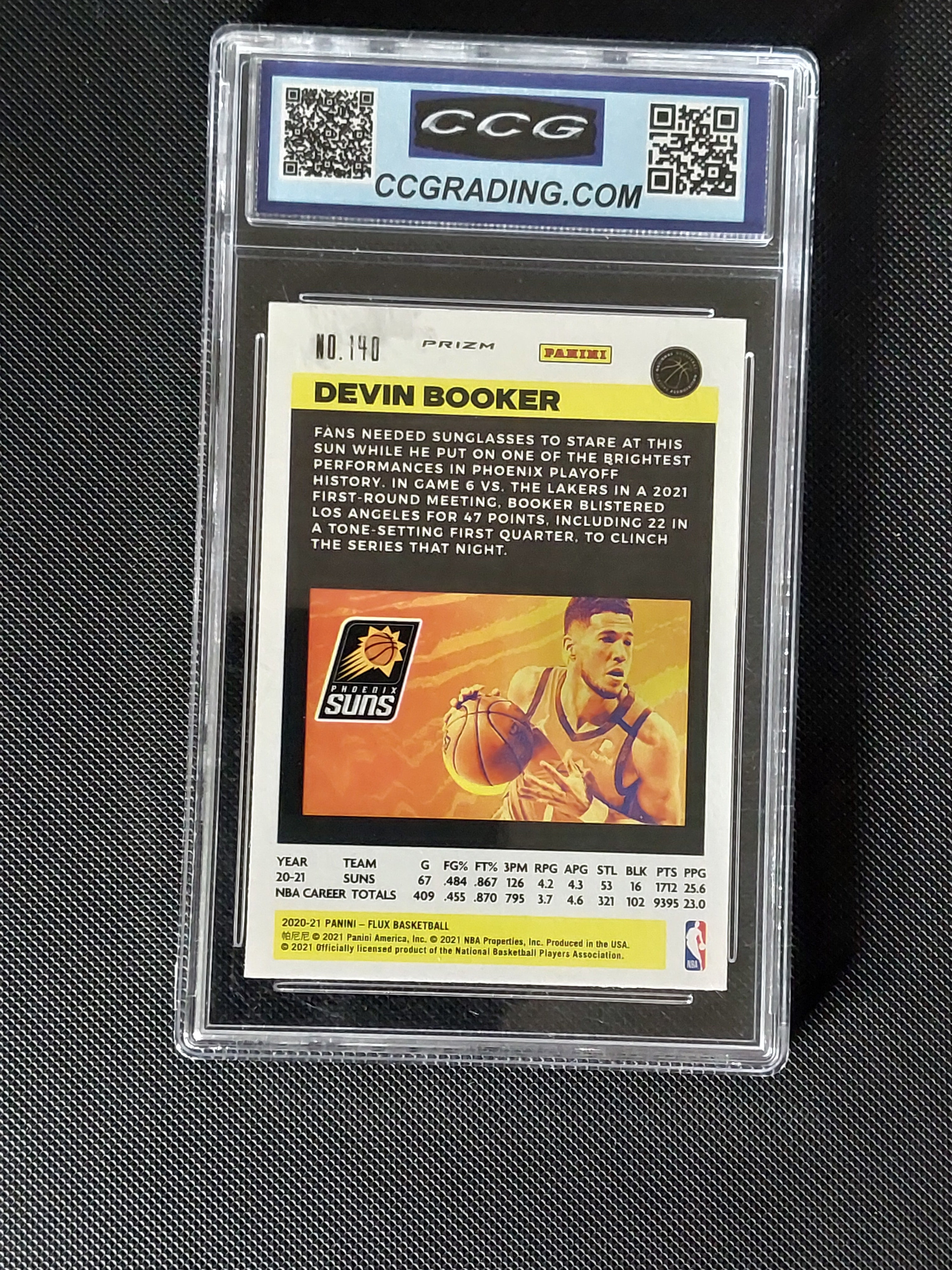 Back of Devin Booker #140 2020-21 Panini Flux Silver Cracked Ice card in CCG Gem Mint 10 slab showing Phoenix Suns player information.