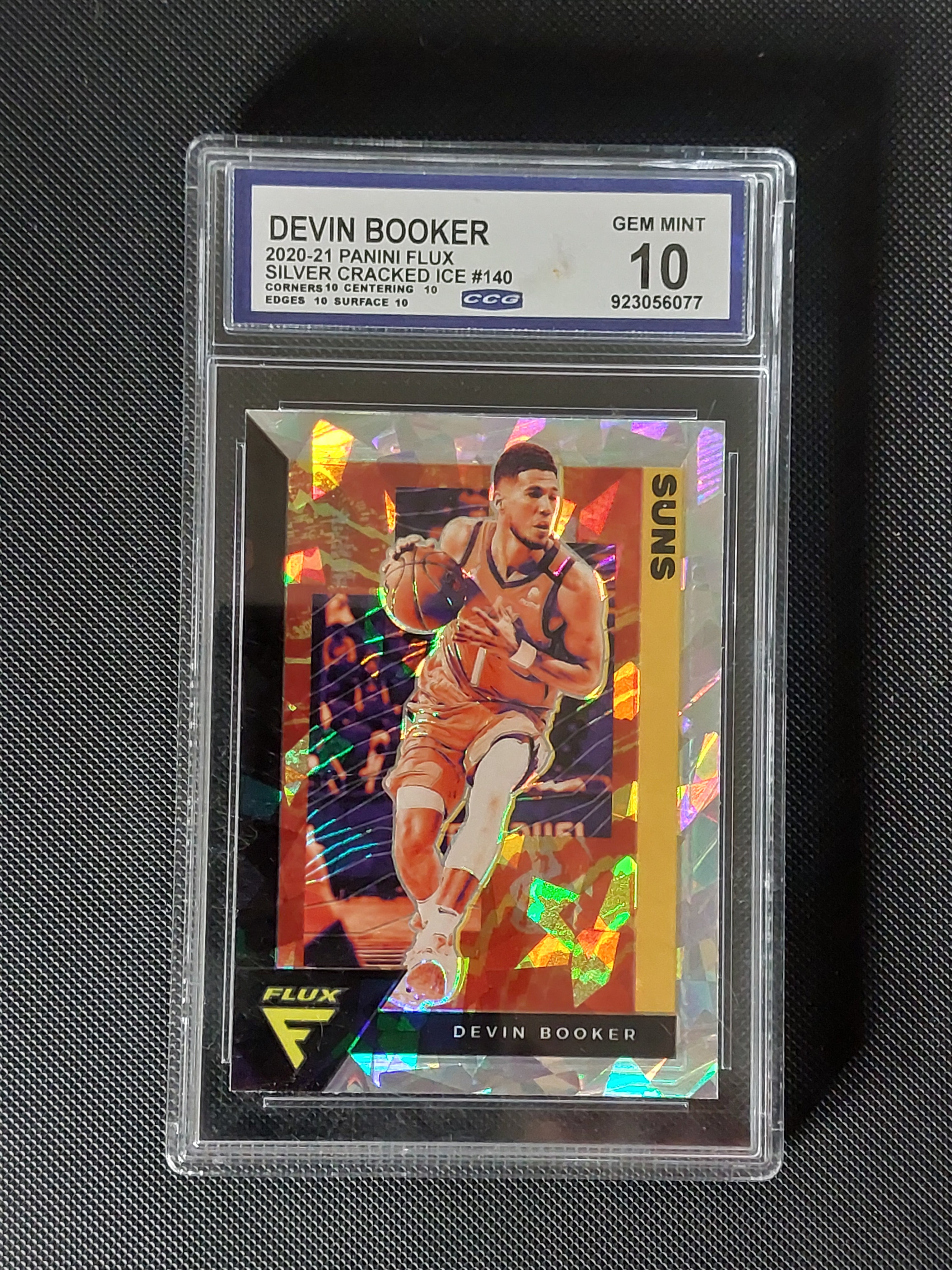 Front of 2020-21 Panini Flux Devin Booker #140 Silver Cracked Ice Phoenix Suns basketball card graded CCG Gem Mint 10.