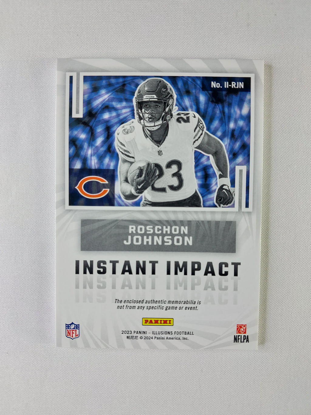 Back of 2023 Panini Illusions Roschon Johnson Instant Impact Blue #II-RJN numbered 019/99 with Panini memorabilia statement.