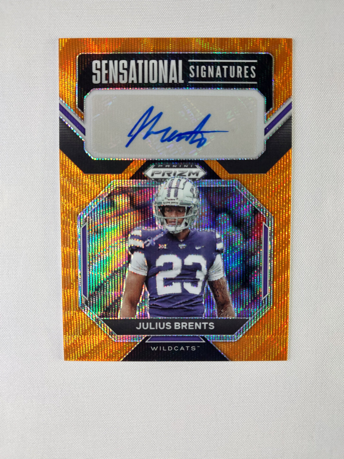 Front of 2023 Panini Prizm Draft Picks Julius Brents Sensational Signatures Orange Wave Prizm rookie autograph numbered 48/75.