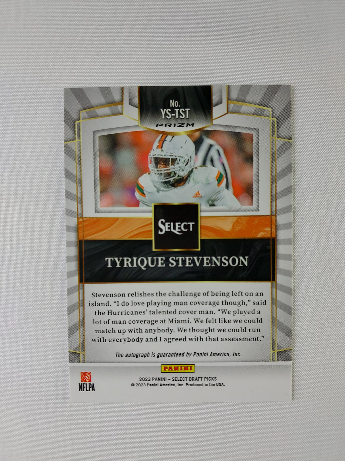 Back of 2023 Panini Select Draft Picks Tyrique Stevenson Youth Explosion Silver Prizm #YS-TST showing Panini's autograph guarantee.