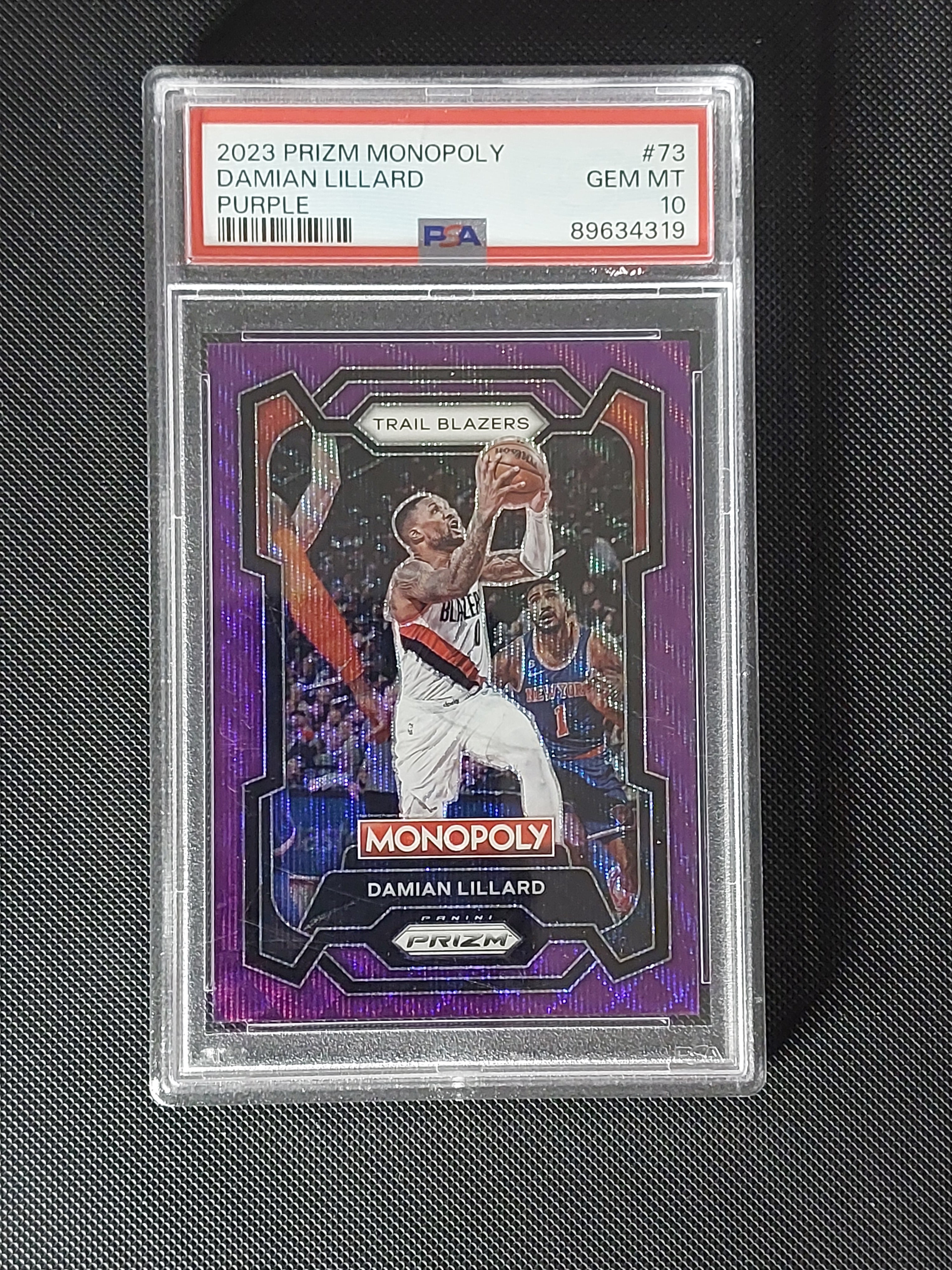 Front of 2023-24 Panini Prizm Monopoly Damian Lillard #73 Purple Prizm graded PSA Gem Mint 10
