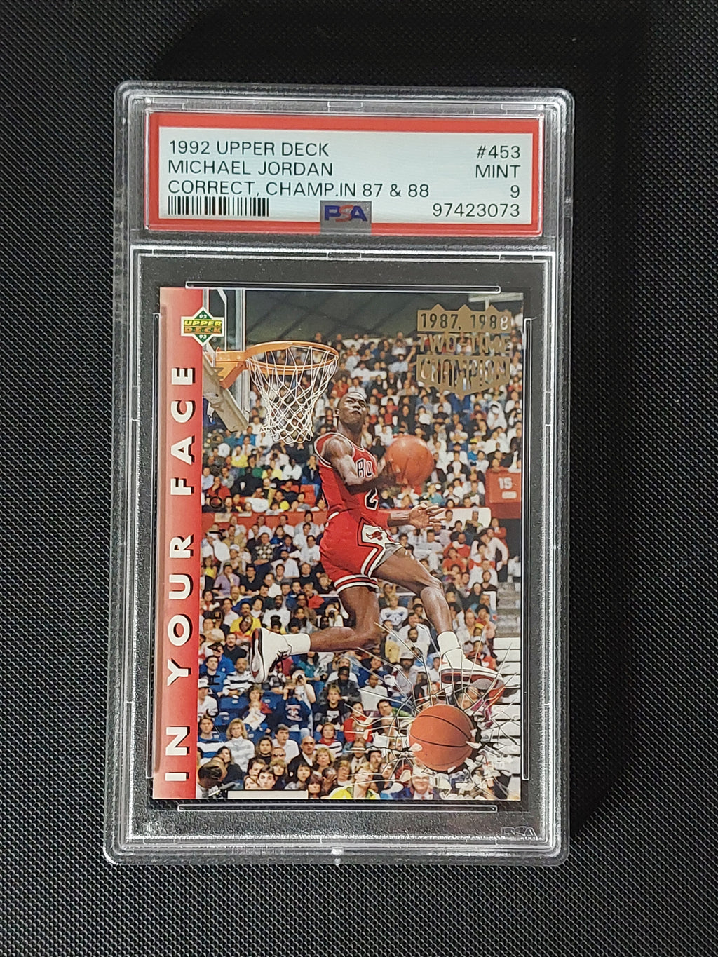 Front of 1992-93 Upper Deck Michael Jordan #453 In Your Face corrected 1987 and 1988 Slam Dunk Championship card graded PSA Mint 9